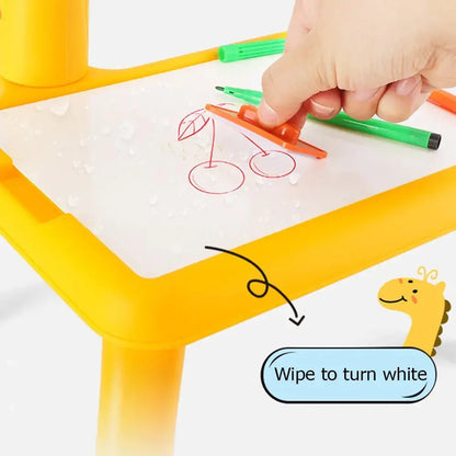 Yellow table with white surface, green and red markers, and a hand drawing on it.