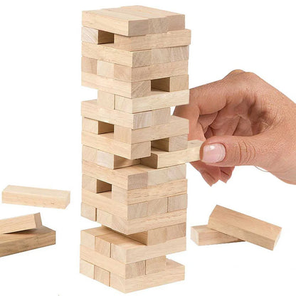 Wooden block tower game with a hand adding a block, on a white background